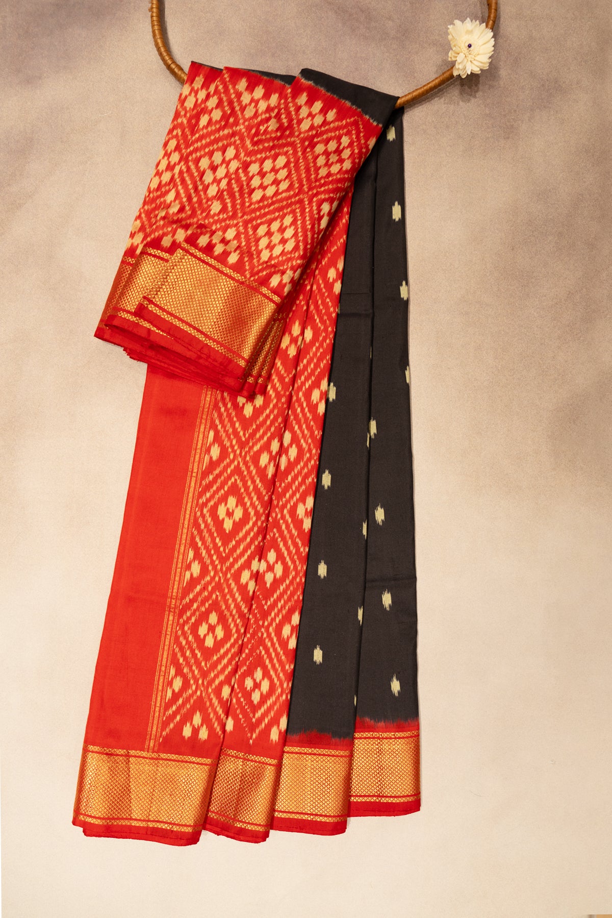 Black patola saree with red border